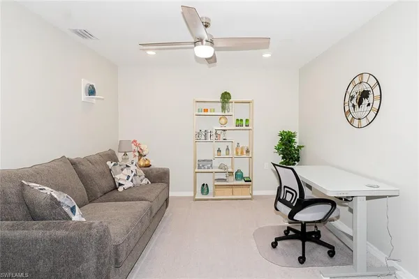 a living room with furniture and a chair