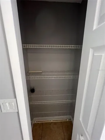 a view of an empty room with a carpet