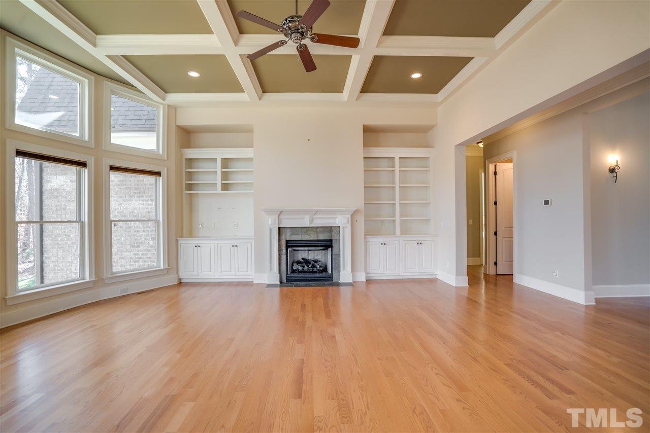 9008 Albatross Court Raleigh, NC 27613 - Photo 12 of 25 a view of an empty room with a window and wooden floor
