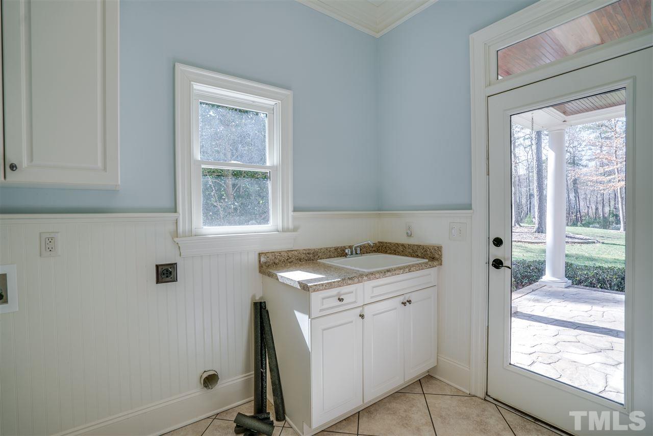 9008 Albatross Court Raleigh, NC 27613 - Photo 14 of 25 a view of a kitchen with washer and dryer