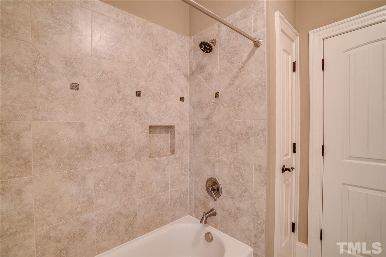 9008 Albatross Court Raleigh, NC 27613 - Photo 22 of 25 a bathroom with a bathtub and shower