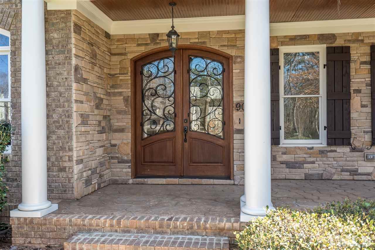 9008 Albatross Court Raleigh, NC 27613 - Photo 6 of 25 a front view of a house with a door and a window