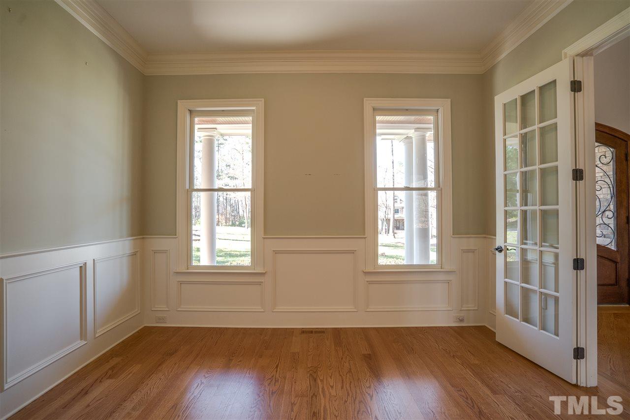9008 Albatross Court Raleigh, NC 27613 - Photo 8 of 25 an empty room with wooden floor and windows