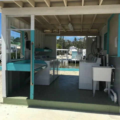 a view of a white house with a yard