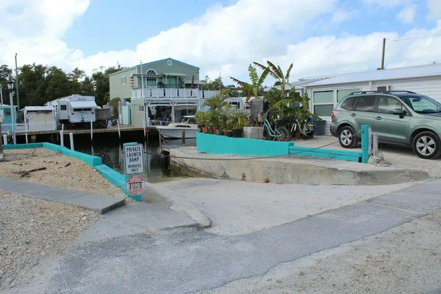 a backyard of a house with yard table and chairs