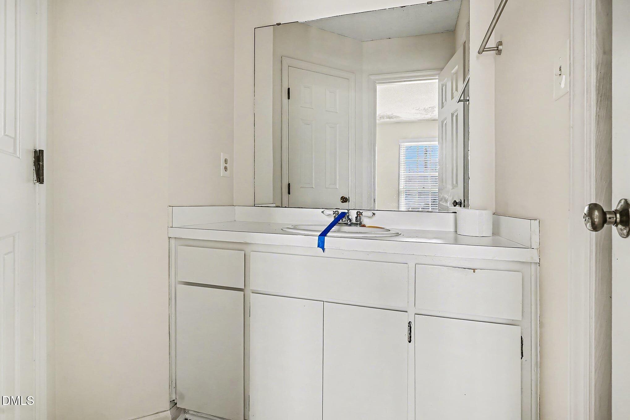 1201 Deptford Court Raleigh, NC 27609 - Photo 11 of 20 a bathroom with a sink and a mirror