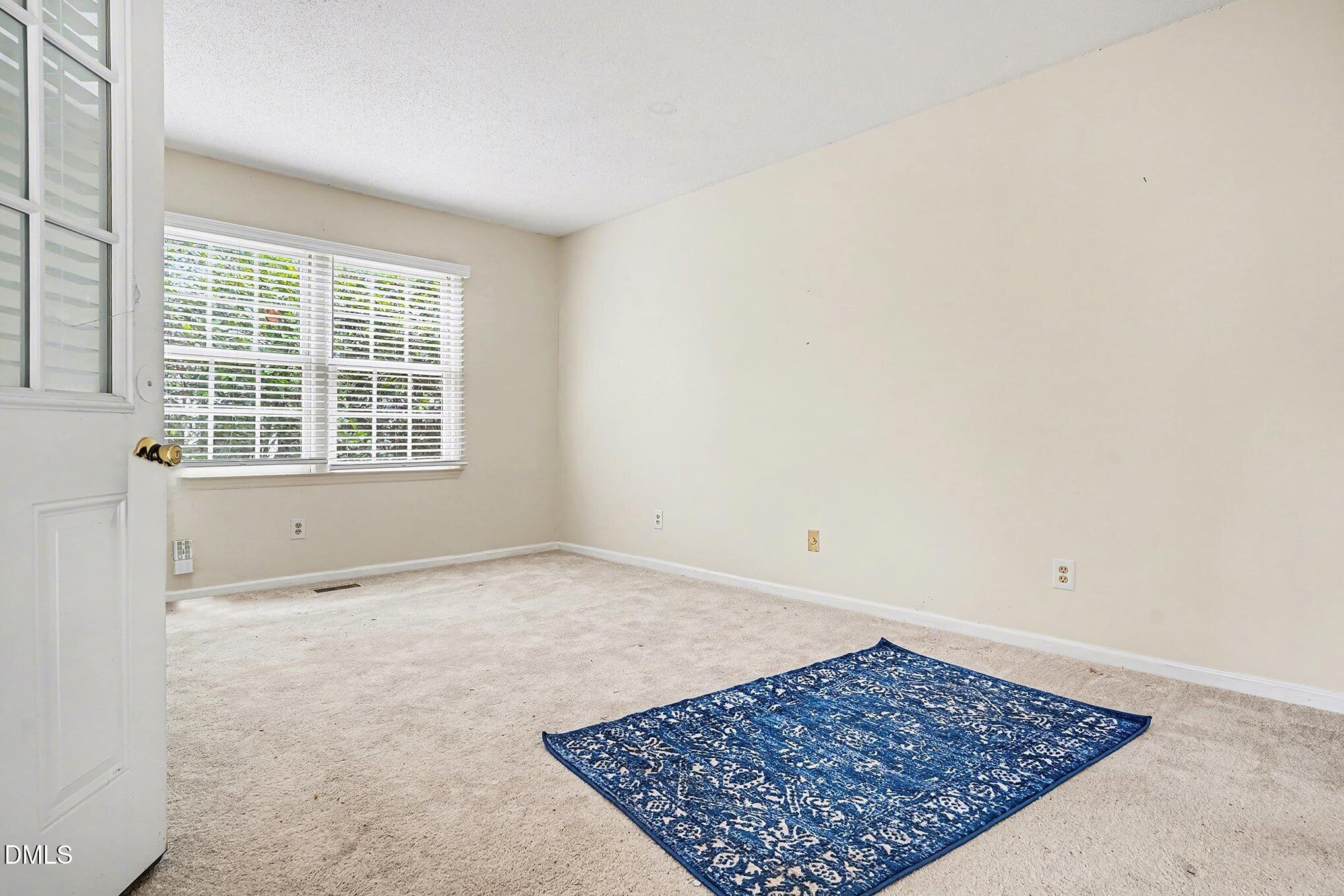 1201 Deptford Court Raleigh, NC 27609 - Photo 14 of 20 an empty room with a rug