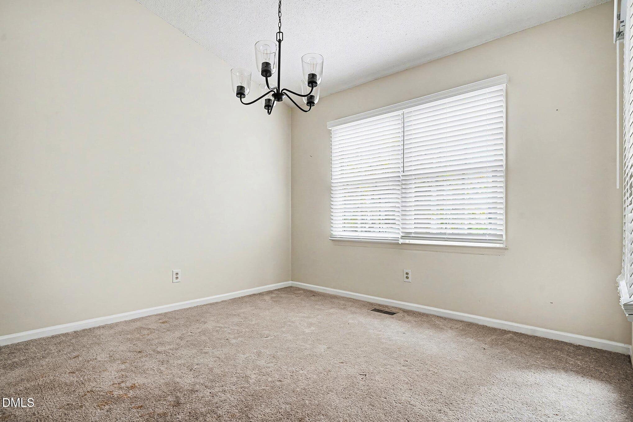 1201 Deptford Court Raleigh, NC 27609 - Photo 4 of 20 a view of an empty room with a window