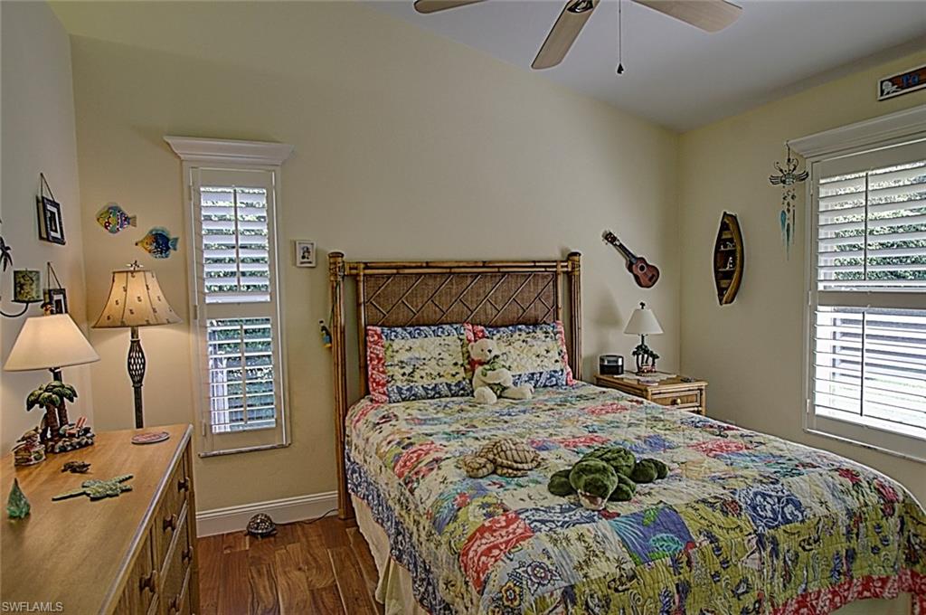 6706 Mill Run Road Naples, FL 34109 - Photo 11 of 20 a bedroom with a bed and wooden floor