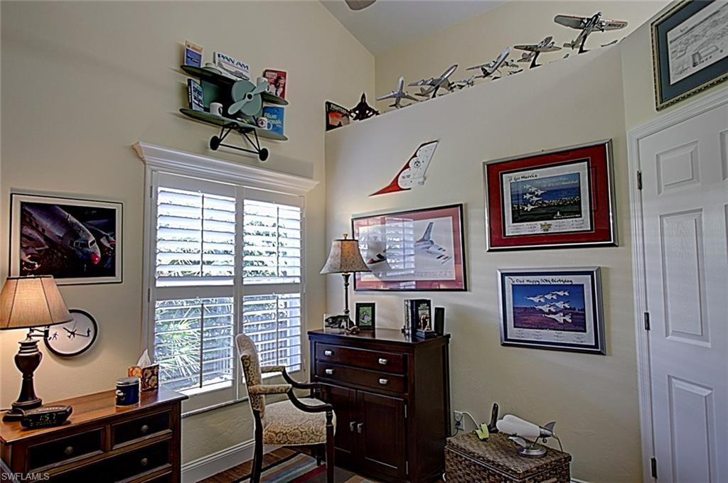 6706 Mill Run Road Naples, FL 34109 - Photo 14 of 20 a view of a workspace with furniture and a window