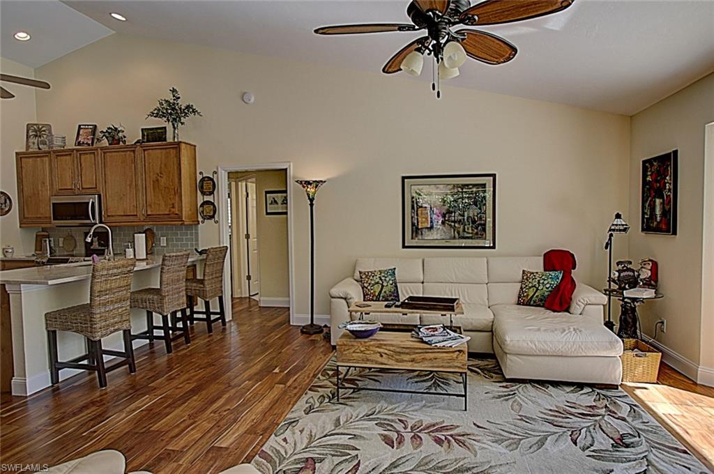 6706 Mill Run Road Naples, FL 34109 - Photo 15 of 20 a living room with furniture and a wooden floor