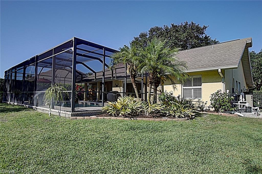 6706 Mill Run Road Naples, FL 34109 - Photo 17 of 20 a view of a house with a yard