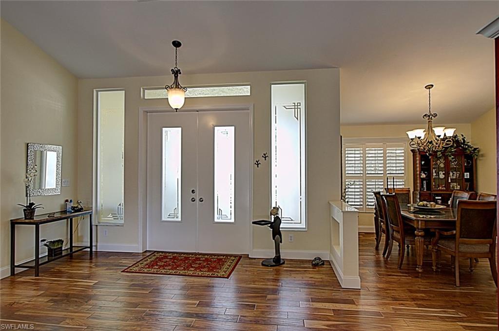 6706 Mill Run Road Naples, FL 34109 - Photo 2 of 20 a view of a dining room with furniture window and wooden floor