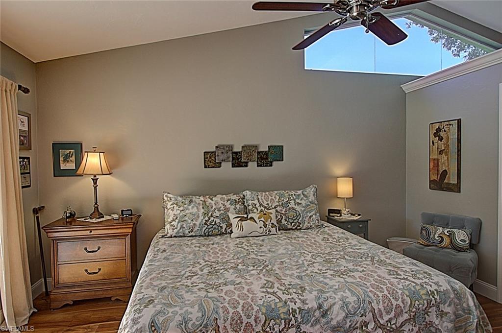 6706 Mill Run Road Naples, FL 34109 - Photo 6 of 20 a bedroom with a bed and a lamp on the dresser