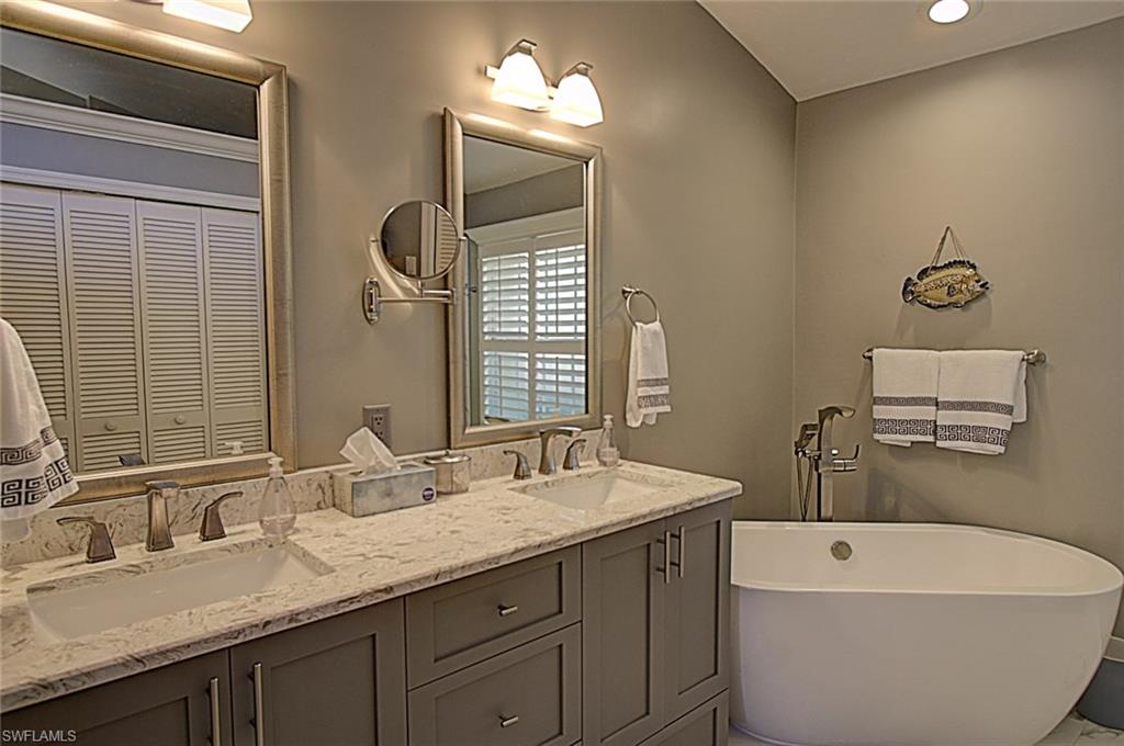6706 Mill Run Road Naples, FL 34109 - Photo 7 of 20 a bathroom with a double vanity sink and a mirror