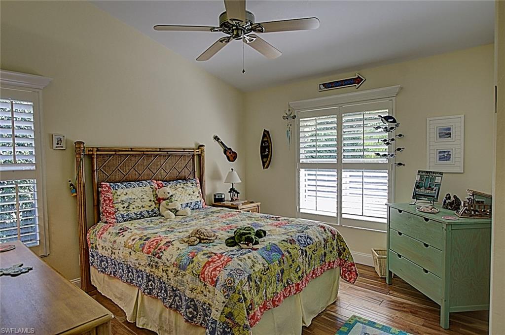 6706 Mill Run Road Naples, FL 34109 - Photo 10 of 20 a bedroom with a large bed and a window