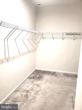 a white toilet sitting next to a white sink and a shower