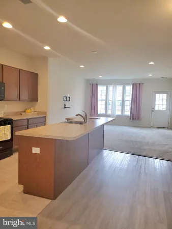 a kitchen with stainless steel appliances a sink a stove a microwave a counter top and cabinets