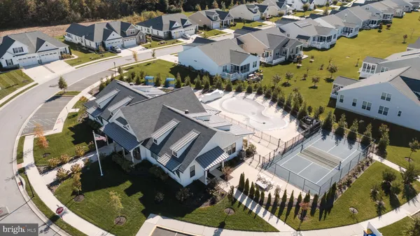 an aerial view of a house with a swimming pool and outdoor seating