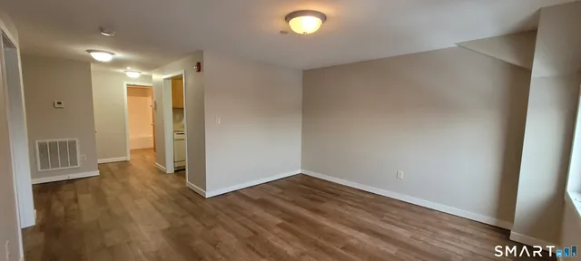 a view of hallway with wooden floor