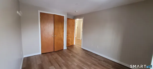 a view of hallway with wooden floor