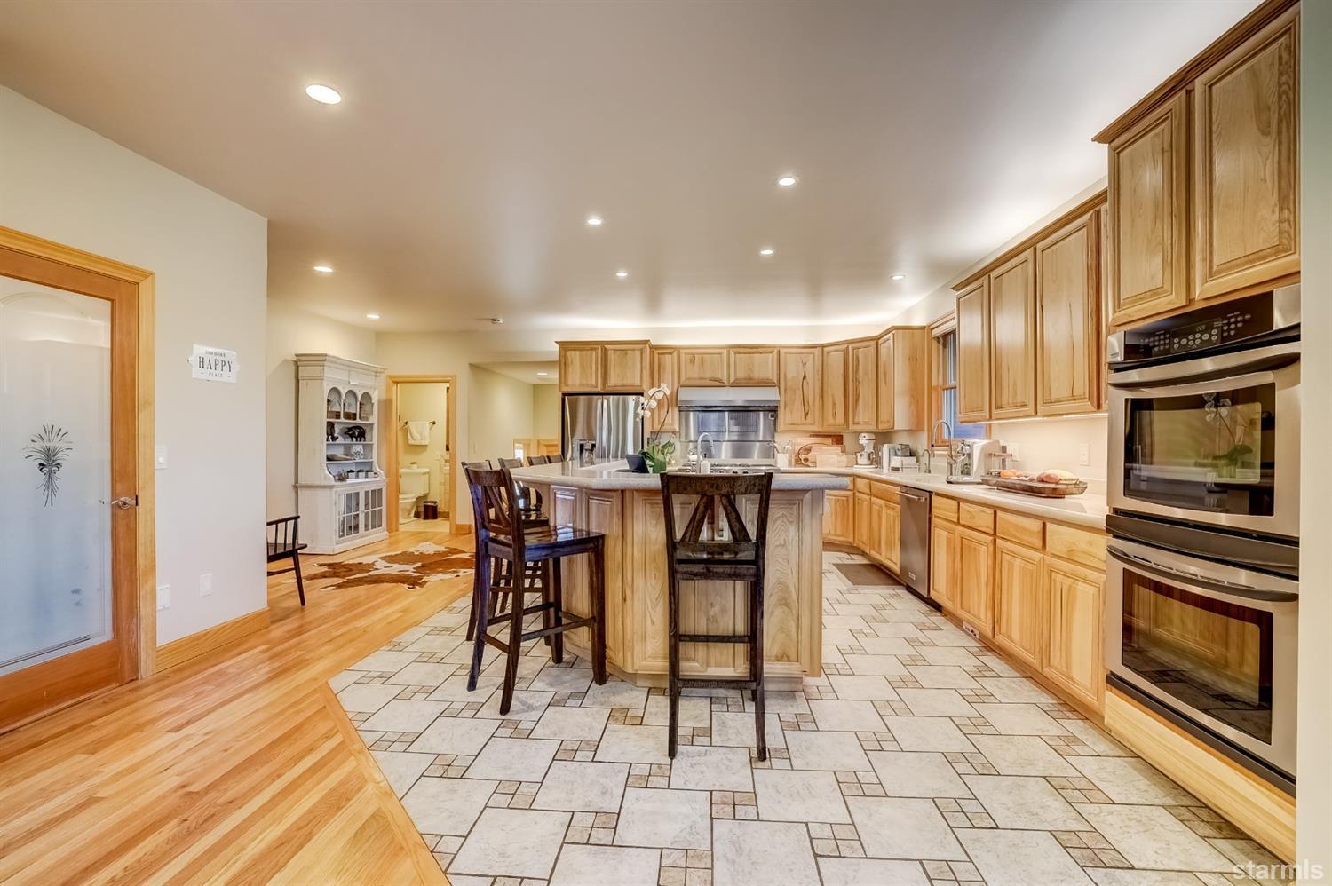 420 River Ranch Road Woodfords, CA 96120 - Photo 3 of 25 a kitchen with stainless steel appliances kitchen island granite countertop a refrigerator and cabinets