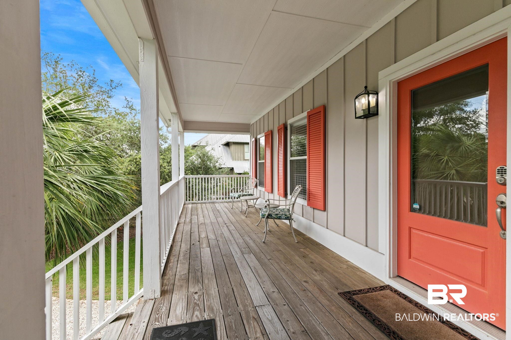 6802 Shore Drive Elberta, AL 36530 - Photo 4 of 34 Spacious covered porch with a wood-finish floor, white railing, and paneled siding