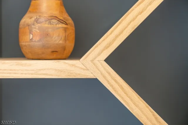 a view of a hallway with wooden floor and a window