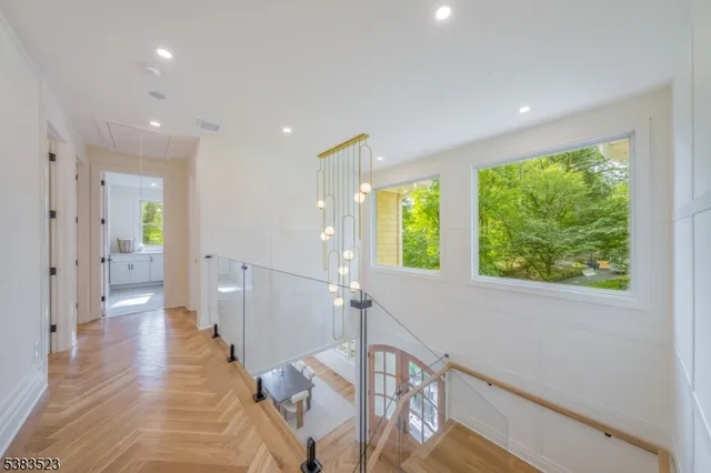 a bedroom with a bed lamps and wooden floor