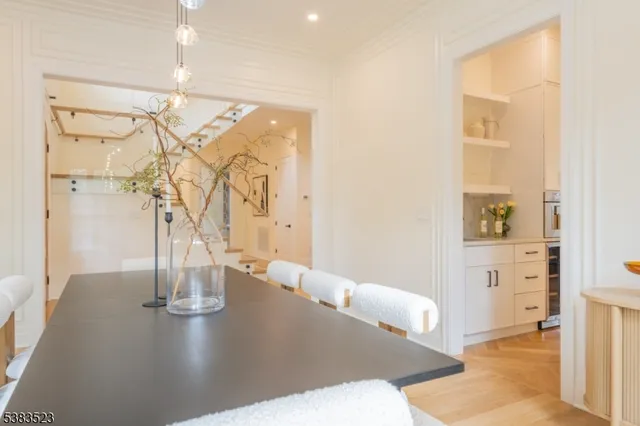 a spacious en suite bathroom with a granite countertop double vanity sink a window and a mirror