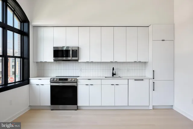 a kitchen with a sink cabinets and appliances