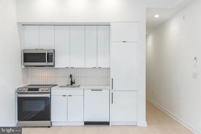 a view of a hallway with washer and dryer