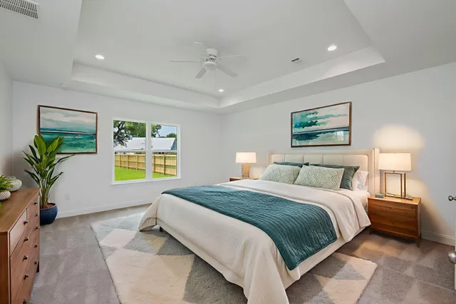 a view of an empty room with wooden floor and windows