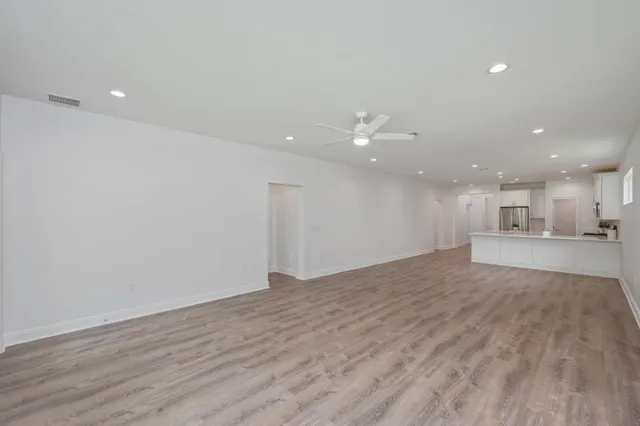 a view of kitchen and hall with wooden floor