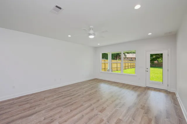an empty room with a window and couch