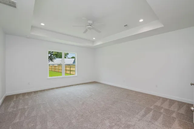 wooden floor in an empty room with a ceiling fan
