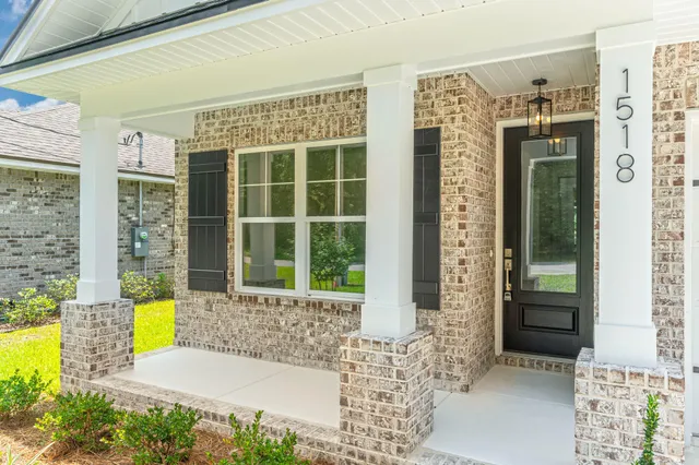 a kitchen with white cabinets stove and refrigerator