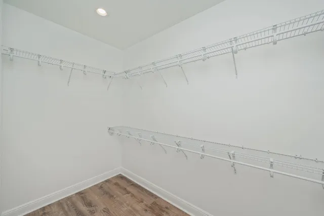 an empty room with a ceiling fan and a window