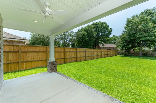 a view of yard with grass and trees