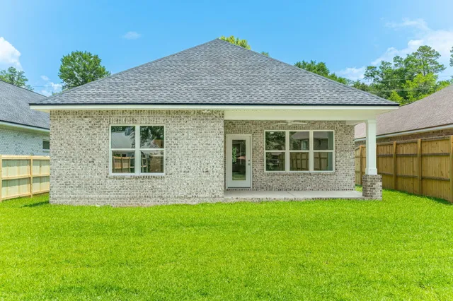 a view of yard with swimming pool and trees in the background