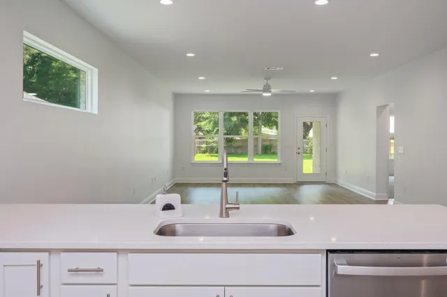 a kitchen with a sink and a stove top oven