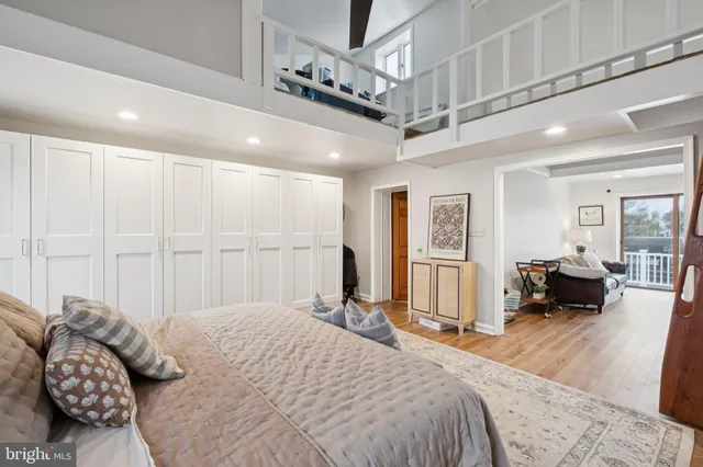 a bedroom with a large bed and a large window