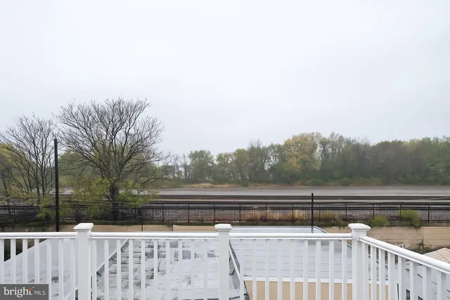 a view of river and trees in the background