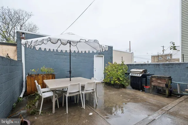 a view of a patio with table and chairs