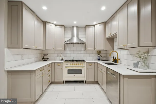 a kitchen with a stove sink and cabinets