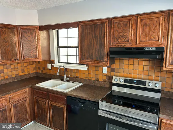a kitchen with a sink cabinets and window