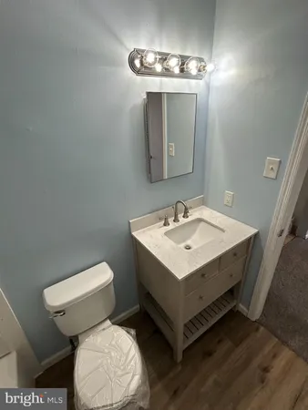 a bathroom with a sink toilet and a mirror