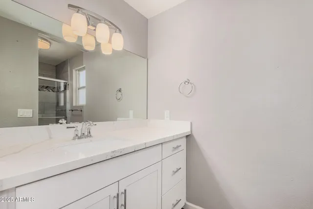 a bathroom with a sink and a mirror