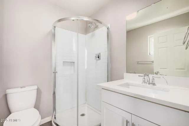 a bathroom with a toilet sink and shower