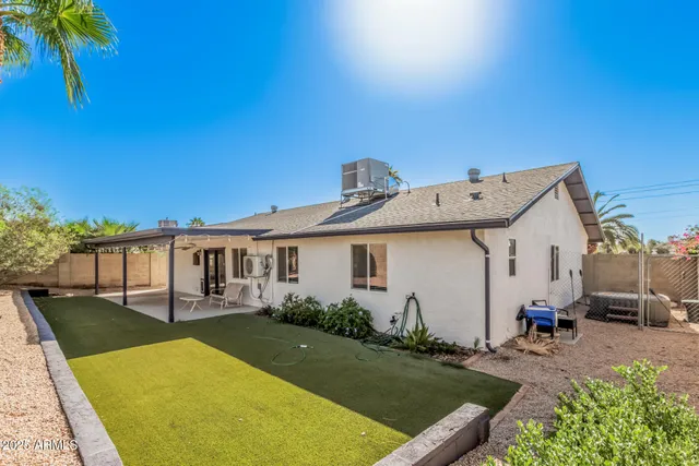 a view of a house with patio yard and swimming pool